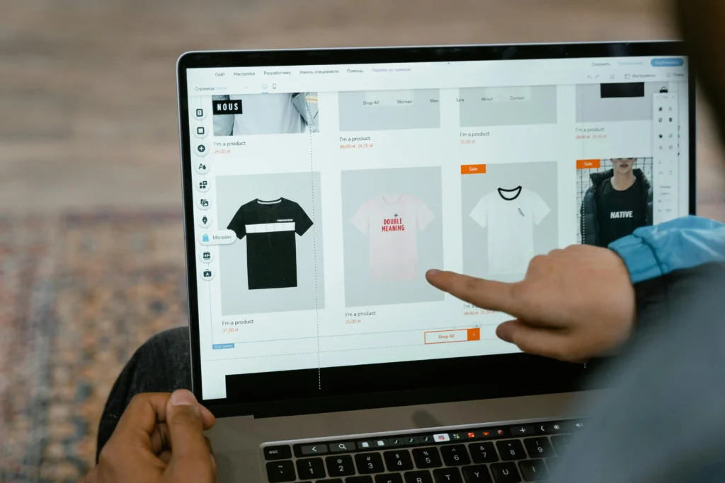 User viewing eCommerce clothing products on an online store website using a laptop