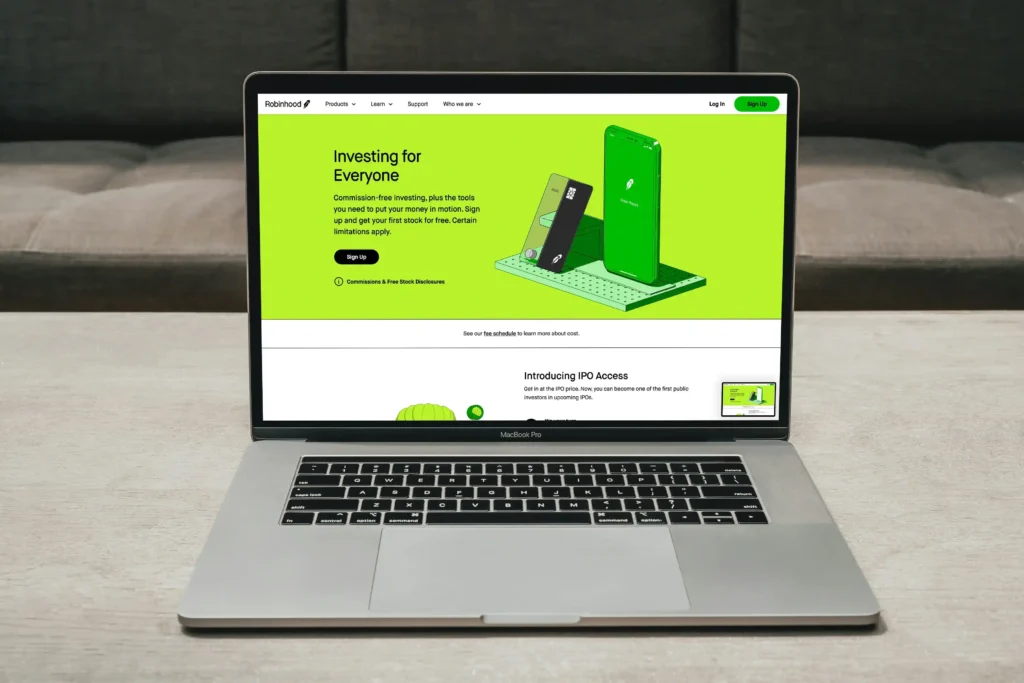 Laptop displaying Robinhood investing website homepage with stock trading and investment platform interface