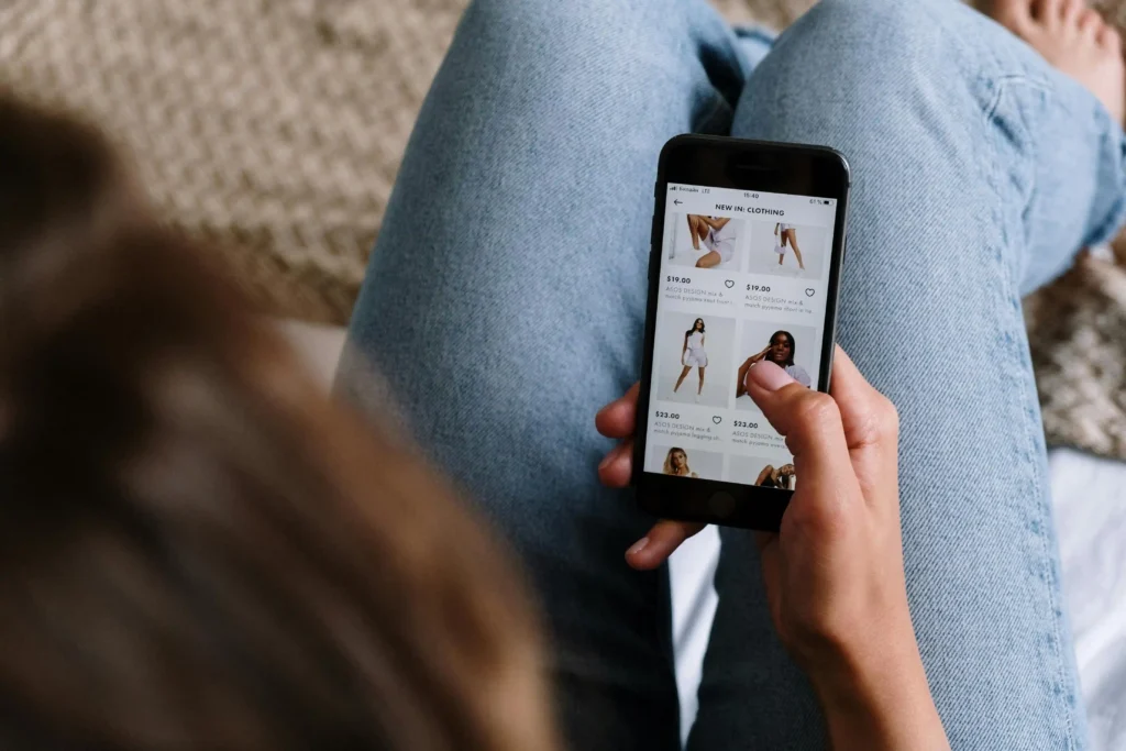 Person browsing clothing product on smartphone