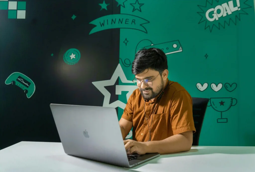 A freelancer is checking Fiverr Fees vs Upwork Fees comparison for freelancers in 2026 on his laptop